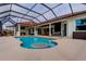 Inviting screened-in pool with ample seating, a swim-up table, and views of the outdoor patio at 6367 Foxbrook Trl, Parrish, FL 34219