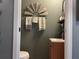 Small bathroom with a sink, toilet, and rustic decor at 6614 Papa Guy Ln, Plant City, FL 33565