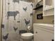 Bathroom with shower/tub combo, white vanity, and farm-style decor at 6614 Papa Guy Ln, Plant City, FL 33565