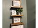 Rustic bathroom shelf with decorative signs and toilet paper at 6614 Papa Guy Ln, Plant City, FL 33565