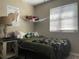 Serene bedroom featuring a double bed and a window with blinds at 6614 Papa Guy Ln, Plant City, FL 33565