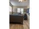 Cozy bedroom with a double bed, gaming chair, and wood-look floors at 6614 Papa Guy Ln, Plant City, FL 33565