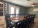 Rustic dining room with a large wooden table and black chairs at 6614 Papa Guy Ln, Plant City, FL 33565