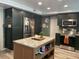 Modern kitchen with dark green cabinets and a large island at 6614 Papa Guy Ln, Plant City, FL 33565
