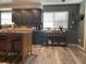 Modern kitchen with dark green cabinets and granite countertop island at 6614 Papa Guy Ln, Plant City, FL 33565