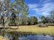 Open pasture with mature trees and a tranquil pond at 6614 Papa Guy Ln, Plant City, FL 33565