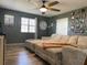 Spacious living room with large sectional sofa and ceiling fan at 6614 Papa Guy Ln, Plant City, FL 33565