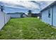 Large grassy backyard with white fence at 7524 Vienna Ln, Port Richey, FL 34668