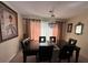 Elegant dining room with dark wood table and chandelier at 7524 Vienna Ln, Port Richey, FL 34668