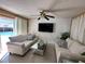 Living room with a view of the pool through sliding glass doors at 7524 Vienna Ln, Port Richey, FL 34668