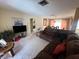 Spacious living room featuring a brown sectional sofa at 7524 Vienna Ln, Port Richey, FL 34668