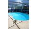 Inviting kidney-shaped pool with screened enclosure at 7524 Vienna Ln, Port Richey, FL 34668