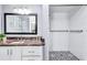 Bathroom with granite countertop, modern vanity, and walk-in shower at 8532 Kumquat Ave, Seminole, FL 33777