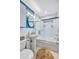 Clean bathroom with pedestal sink, tub, and a modern glass shower at 8532 Kumquat Ave, Seminole, FL 33777