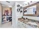 Bathroom with granite countertop, white cabinets and walk-in closet at 8532 Kumquat Ave, Seminole, FL 33777