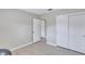 Bright bedroom with light flooring, double door closet, and access to bathroom at 8532 Kumquat Ave, Seminole, FL 33777