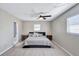 Spacious bedroom with queen bed, light flooring, and ceiling fan at 8532 Kumquat Ave, Seminole, FL 33777