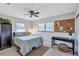 Bright bedroom with a comfortable bed, ceiling fan, and built-in workspace at 8532 Kumquat Ave, Seminole, FL 33777