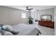 Primary bedroom with dresser, large bed, and access to the bathroom at 8532 Kumquat Ave, Seminole, FL 33777