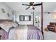 Spacious bedroom with a large bed, ceiling fan, and plenty of natural light at 8532 Kumquat Ave, Seminole, FL 33777