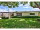 Ranch style home with carport and well-manicured lawn at 8532 Kumquat Ave, Seminole, FL 33777