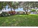 Landscaped lawn with mature shade trees and a charming home at 8532 Kumquat Ave, Seminole, FL 33777