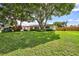 Spacious yard with lush greenery, large trees and a house at 8532 Kumquat Ave, Seminole, FL 33777