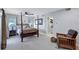 Spacious main bedroom with a post bed and access to the bathroom at 8532 Kumquat Ave, Seminole, FL 33777