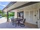 Covered patio with outdoor dining set and view of the pool at 8532 Kumquat Ave, Seminole, FL 33777