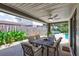 Relaxing patio area with table and chairs, adjacent to the pool at 8532 Kumquat Ave, Seminole, FL 33777