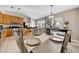 Dining area with a large farmhouse table and view to kitchen at 10458 River Bream Dr, Riverview, FL 33569