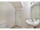 Simple bathroom with pedestal sink, toilet, and storage at 10805 Keys Gate Dr, Riverview, FL 33579