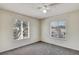 Bedroom with two windows, ceiling fan, and grey carpet at 10805 Keys Gate Dr, Riverview, FL 33579