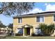 Two-story yellow townhome with landscaping at 10805 Keys Gate Dr, Riverview, FL 33579