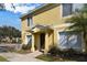 Front entrance of yellow townhome at 10805 Keys Gate Dr, Riverview, FL 33579