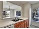 Kitchen with wood cabinets, double sink, and view to dining area at 10805 Keys Gate Dr, Riverview, FL 33579