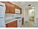 Kitchen boasts wood cabinets, marble countertops and appliances at 10805 Keys Gate Dr, Riverview, FL 33579