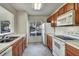 Galley kitchen with wood cabinets, appliances, and a window at 10805 Keys Gate Dr, Riverview, FL 33579
