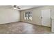 Bright living room with tile floors, ceiling fan, and view of the backyard at 10805 Keys Gate Dr, Riverview, FL 33579