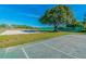 Community park featuring a sand volleyball court, a large tree for shade, and well-maintained tennis courts at 10805 Keys Gate Dr, Riverview, FL 33579