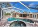 Relaxing kidney-shaped pool with a spa and covered lanai at 10834 96Th St, Largo, FL 33773