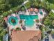 Overhead view of an inviting community pool, featuring lounge areas, a spa, and lush landscaping, perfect for relaxation and enjoyment at 11125 Callisia Dr, Odessa, FL 33556
