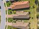 Aerial view of homes with well-manicured lawns, beautiful landscaping, and brick-paved driveways in a friendly neighborhood at 11125 Callisia Dr, Odessa, FL 33556