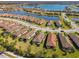 An aerial view of homes in a Primary-planned community with tranquil lakes in the background at 11125 Callisia Dr, Odessa, FL 33556