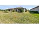 Expansive green backyard with well-maintained lawn and mature landscaping, perfect for outdoor activities at 11125 Callisia Dr, Odessa, FL 33556