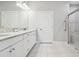 Modern bathroom features double sinks, granite counters and glass-enclosed shower at 11125 Callisia Dr, Odessa, FL 33556