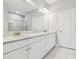 Bright bathroom featuring double sinks with granite counters and a large mirror at 11125 Callisia Dr, Odessa, FL 33556