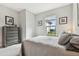 Bedroom featuring soft lighting, large window with exterior view, and modern dresser at 11125 Callisia Dr, Odessa, FL 33556