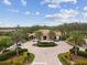 A vibrant clubhouse entrance with manicured landscaping, a circular driveway, and ample parking for residents and guests to enjoy at 11125 Callisia Dr, Odessa, FL 33556