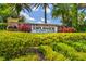 Inviting community entrance sign surrounded by lush greenery and manicured landscaping, showcasing a warm welcome to residents and visitors at 11125 Callisia Dr, Odessa, FL 33556